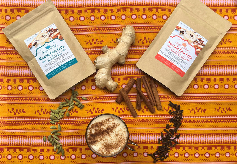 Mumbai Chai and Masaala Chai Latte Packets Displayed with Herbs and Brewed Latte 